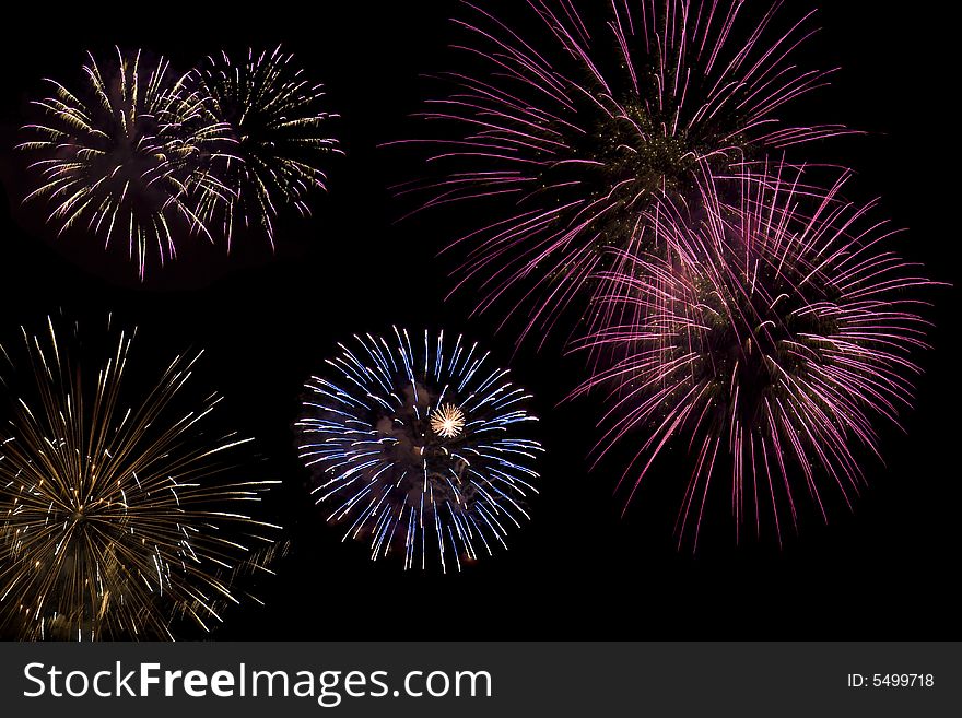 Multiple colored fireworks exploding in the sky. Multiple colored fireworks exploding in the sky.