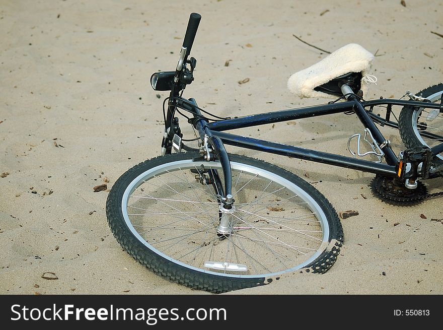 Bicycle lying on the beach in Santa Cruz, California. Bicycle lying on the beach in Santa Cruz, California