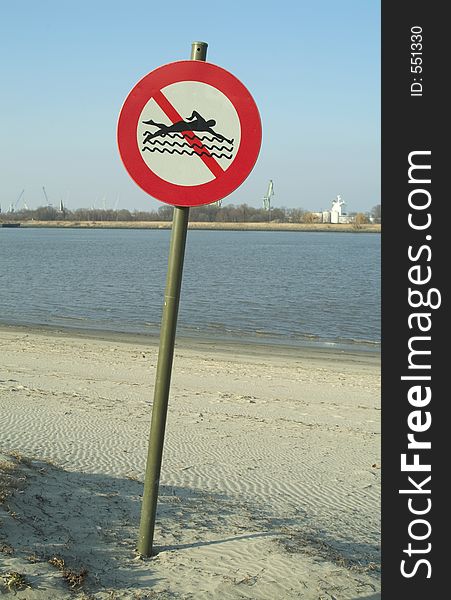 Sign on the left bank of the river Scelde (Antwerp, Belgium) : forbidden to swim. Sign on the left bank of the river Scelde (Antwerp, Belgium) : forbidden to swim