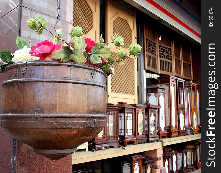 Flower pot hanging with oriental lights in the background. Flower pot hanging with oriental lights in the background