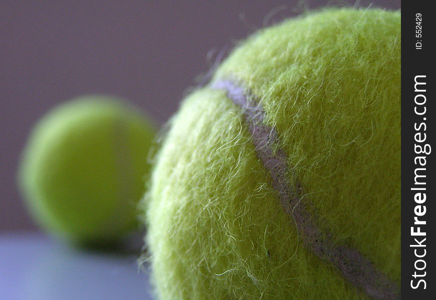 Tennis balls at different depths of field.