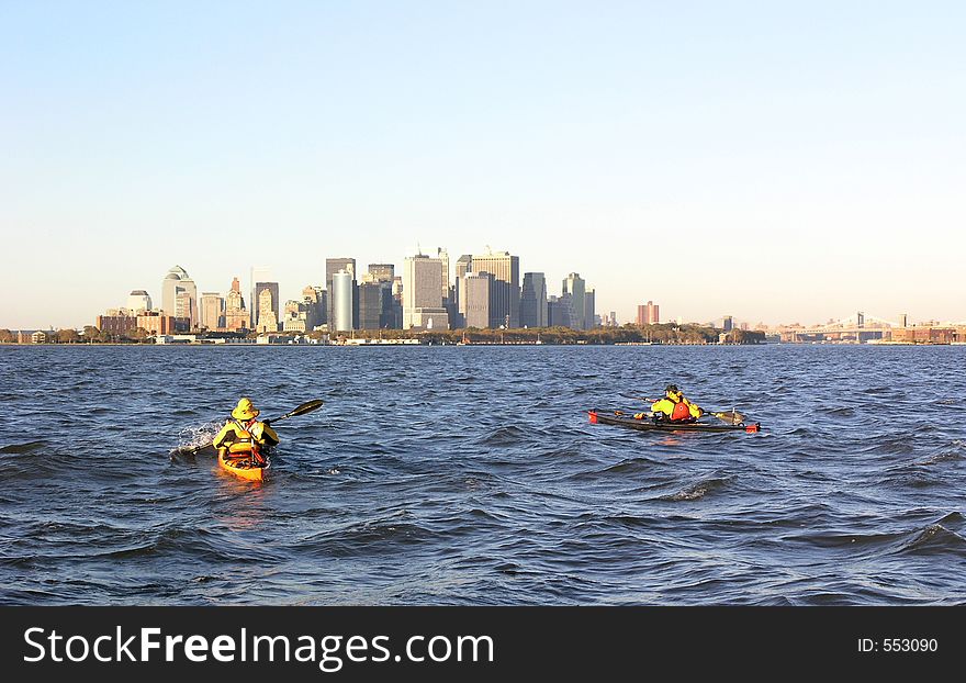 Photo of two kayakers with the Manhattan skyline in the background. Photo of two kayakers with the Manhattan skyline in the background