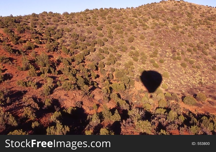 Hot air balloon shadow on the desert floor. Hot air balloon shadow on the desert floor.