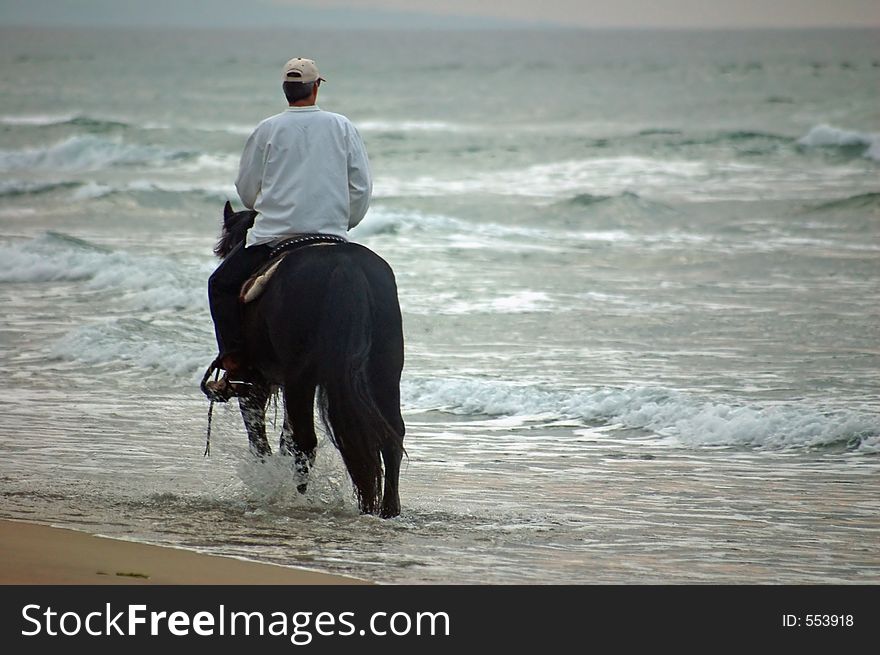 Riding into the sunset on the beach