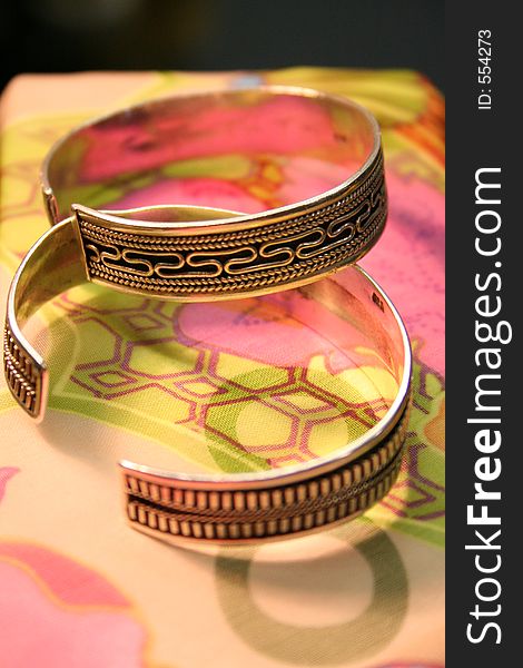 Close up view of 2 bangles against a pastel background