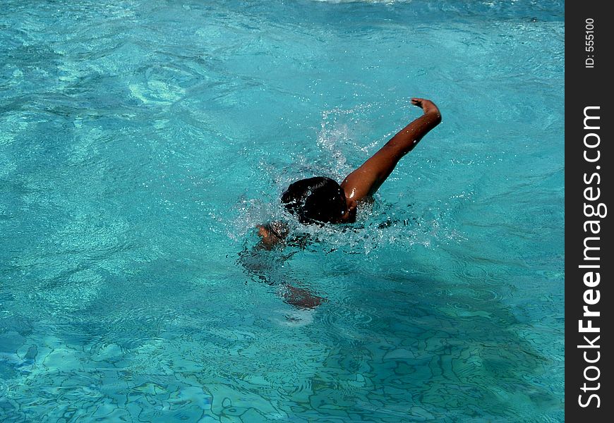 A lone swimmer enjoying his swimming activity.