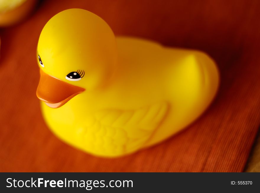 Rubber ducky with shallow depth of field. Bright orange and gold colors