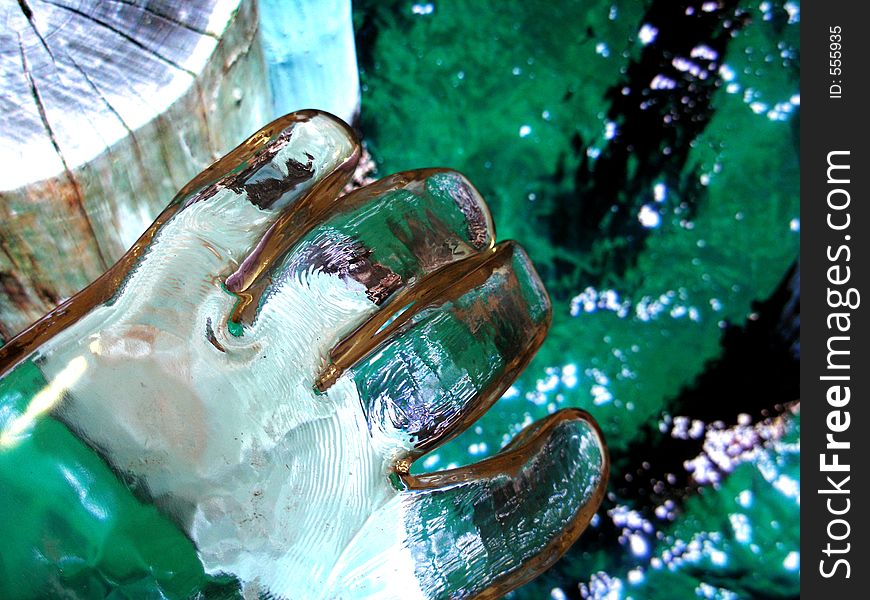 Cool aqua shadows reflected in glass hand. Cool aqua shadows reflected in glass hand