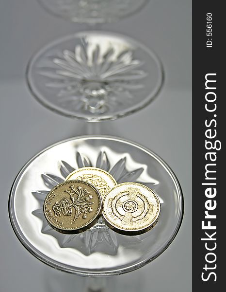 Britian coins on the base of a wine glass. Britian coins on the base of a wine glass