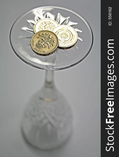 Britian coins on the base of a wine glass. Britian coins on the base of a wine glass