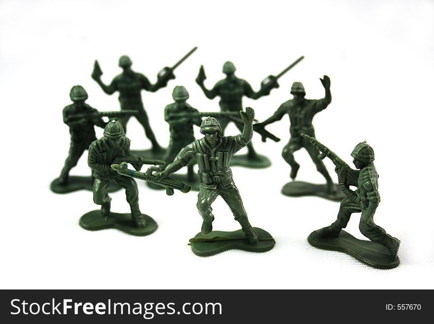 Green army men surrounded on white