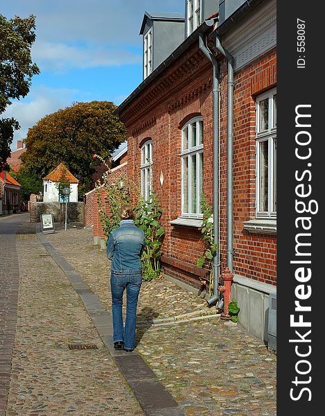 Woman walking down an old street. Woman walking down an old street
