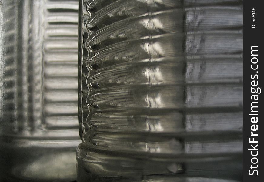 Close view of newly manufactured textured glass bottles with no (i.e. clear) tint. Close view of newly manufactured textured glass bottles with no (i.e. clear) tint.