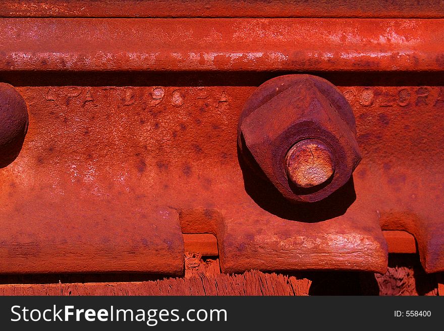 Close-up of a rusted bolt holding together a rusted railroad junction. Close-up of a rusted bolt holding together a rusted railroad junction.