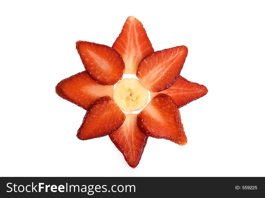 A banana surrounded by sliced strawberries. A banana surrounded by sliced strawberries