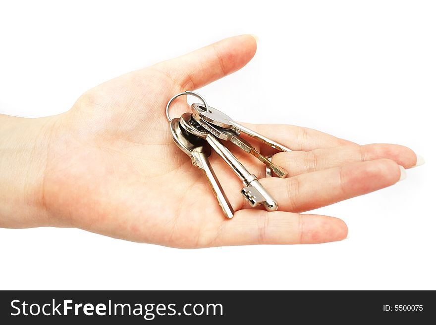 A bunch of keys on lady's hand over white background. A bunch of keys on lady's hand over white background.