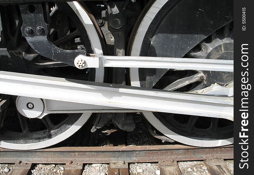 Black train wheels close-up on a track