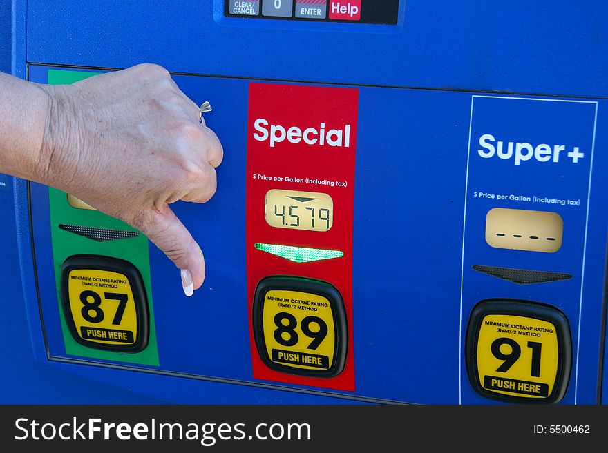 Gas prices keep going up. A woman's hand is giving the thumbs down to the high price of mid grade (Special) at 4.579 a us gallon. Gas prices keep going up. A woman's hand is giving the thumbs down to the high price of mid grade (Special) at 4.579 a us gallon