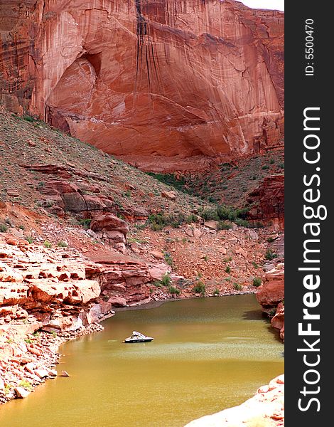 A boat floats in a deep canyon at Lake Powell, Utah. A boat floats in a deep canyon at Lake Powell, Utah.