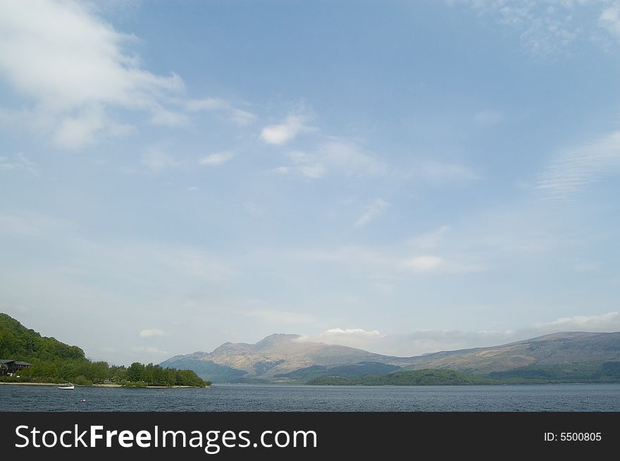 A lovely shot of distant mountains and
loch lomond in scotland. A lovely shot of distant mountains and
loch lomond in scotland
