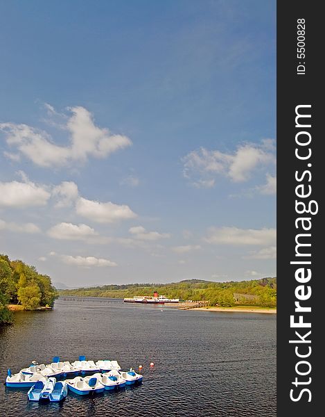 Boats in the quietness of the loch near balloch on loch lomond in scotland. Boats in the quietness of the loch near balloch on loch lomond in scotland