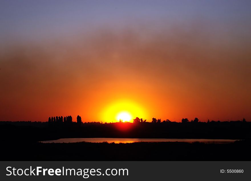 Red sunset near a lake