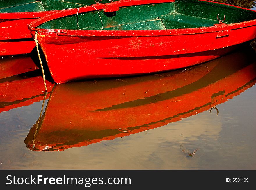 Red boats and their reflections