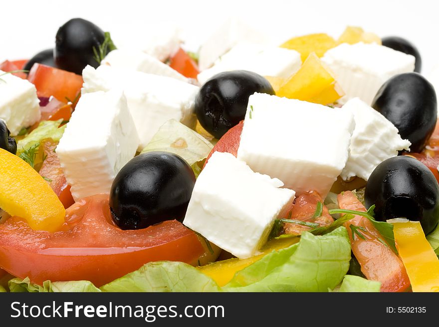 Appetizing Greek salad on a plate. Close up.