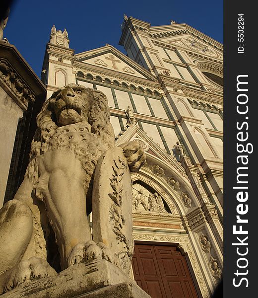 A statue of a lion before the facade of S.Croce church in Florence. A statue of a lion before the facade of S.Croce church in Florence