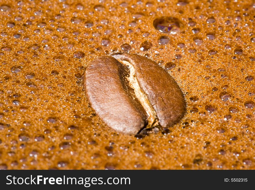 Coffee beans in foam of boiled coffee