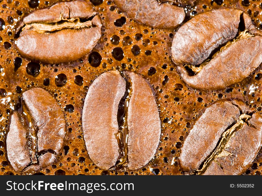 Coffee beans in foam of boiled coffee