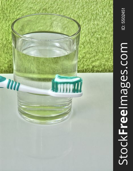 Toothbrush with toothpaste and glass of water. Toothbrush with toothpaste and glass of water