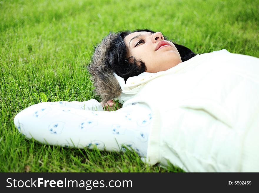 Beautiful girl lying down of grass