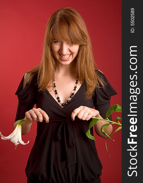Angry girl breaking the flower isolated on red background. Angry girl breaking the flower isolated on red background