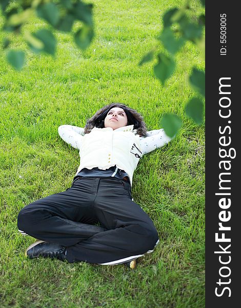 Beautiful girl lying down of grass