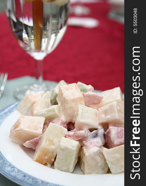 Appetizing salad on a plate with cup of drinking. Close up