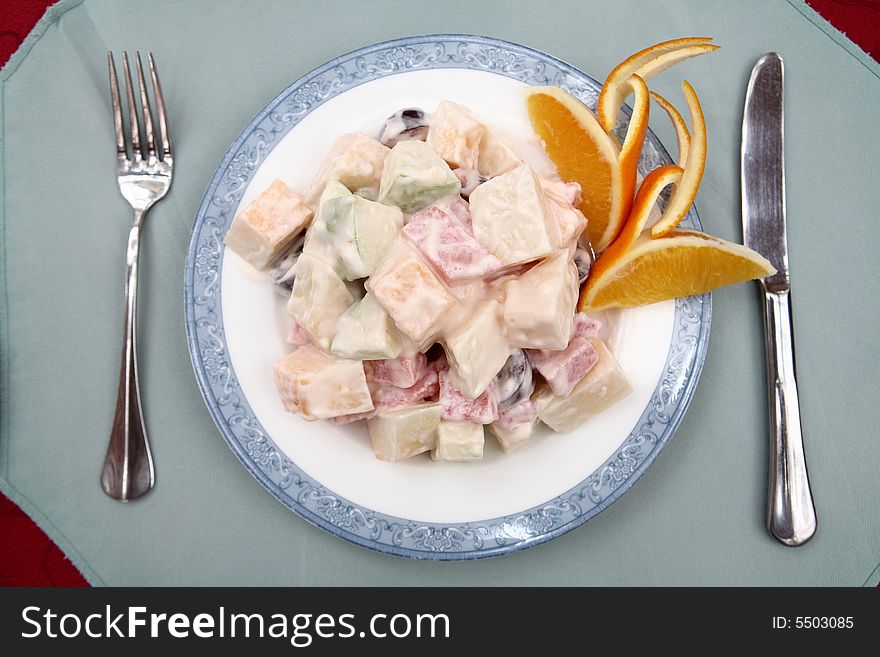 Appetizing salad on a plate with knife and fork