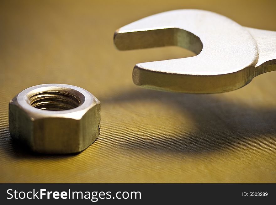 Close-up of a tool to a nut. Close-up of a tool to a nut