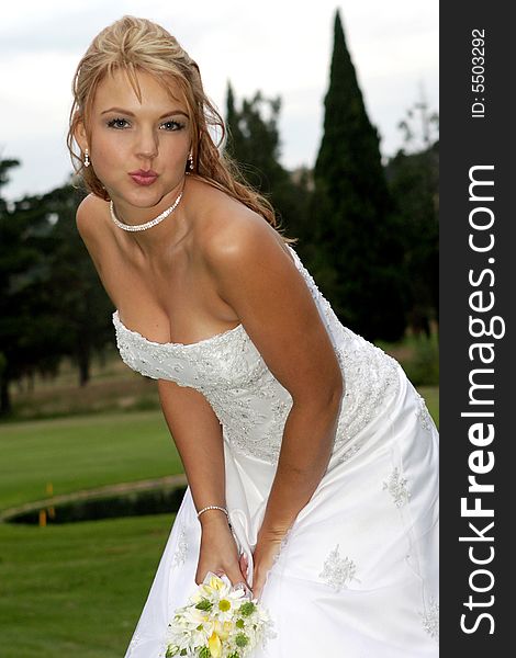 A bride blowing a kiss to camera. A bride blowing a kiss to camera