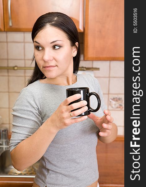 Attractive woman  with coffee in kitchen