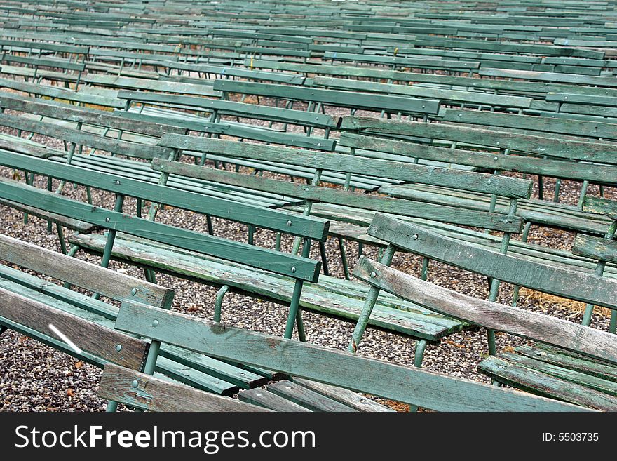 Green benches in a row