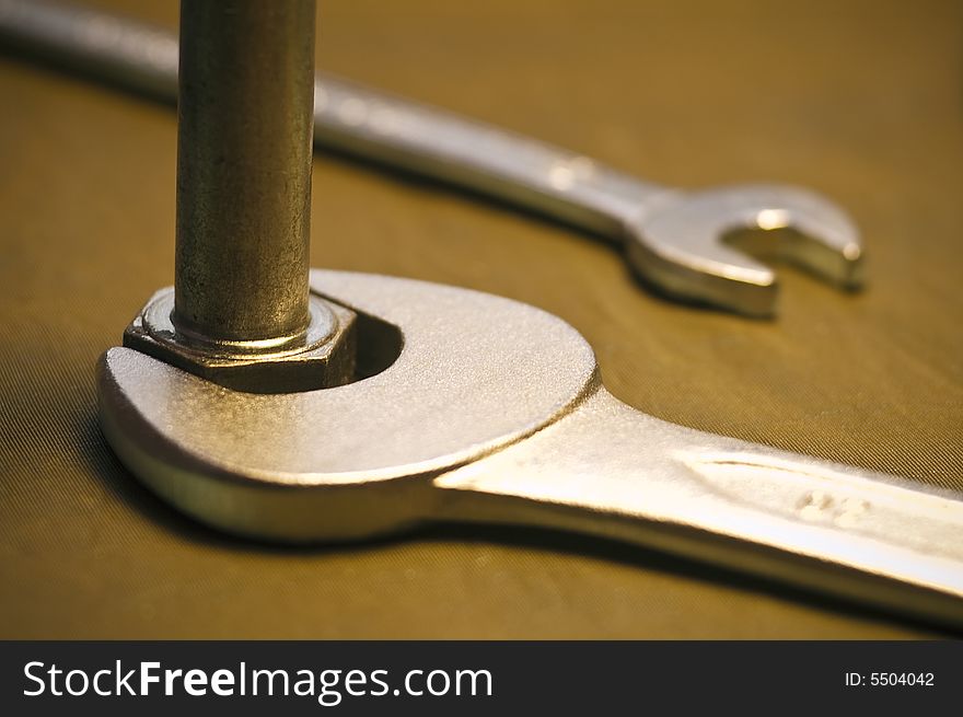 Close-up of a tool to a nut. Close-up of a tool to a nut