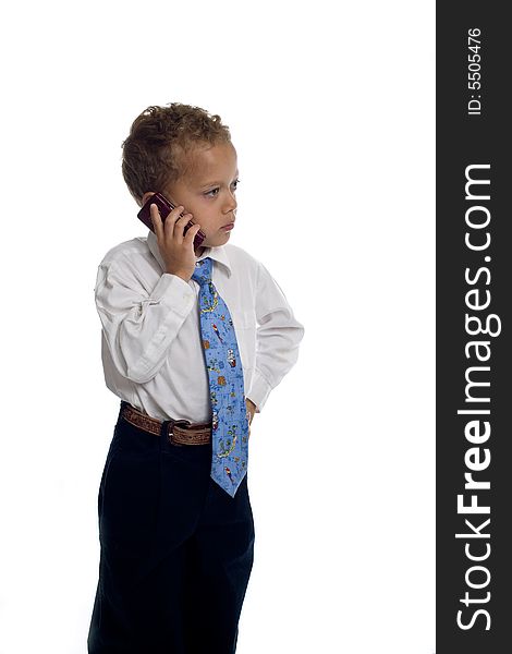 Young boy dressed as businessman talks on the mobile phone - isolated on white. Young boy dressed as businessman talks on the mobile phone - isolated on white