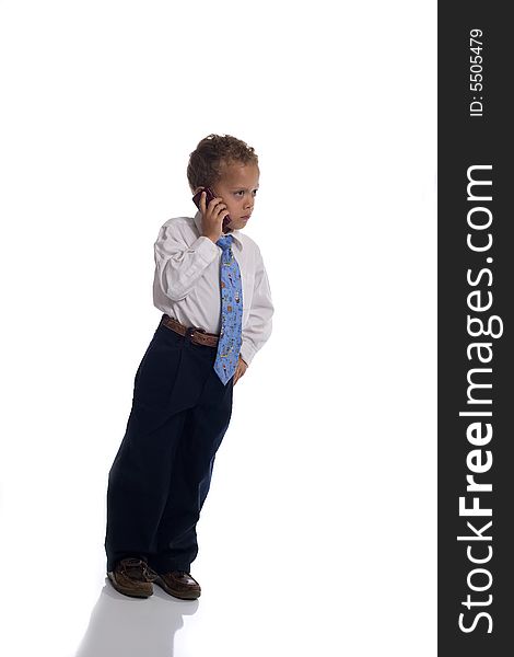 Young boy dressed as businessman uses cellphone