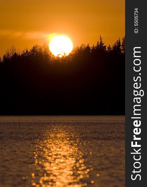 Summer sunset on forest lake in Karelia