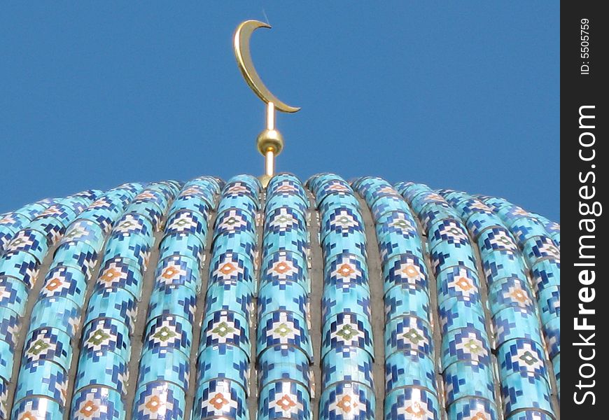 A fragment of the cupola of St. Petersburg's cathedral mosque on the blue sky background. Ceramic pattern. A fragment of the cupola of St. Petersburg's cathedral mosque on the blue sky background. Ceramic pattern.