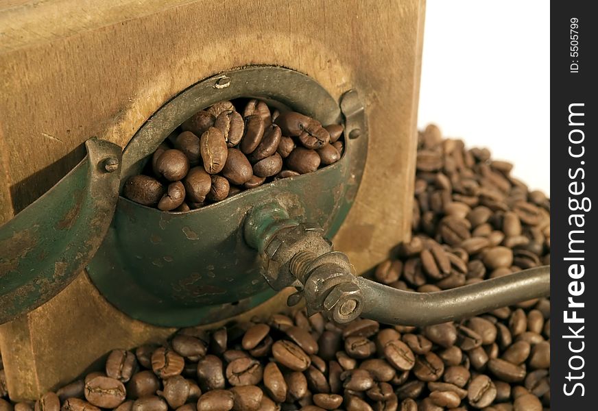 Old coffee mill with beans