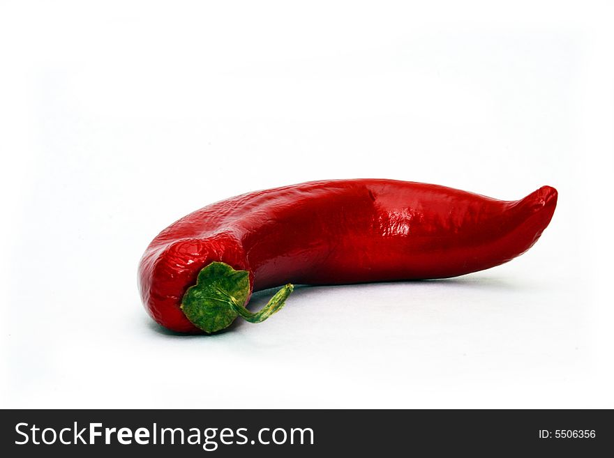 Single hot red chili peppers on white background