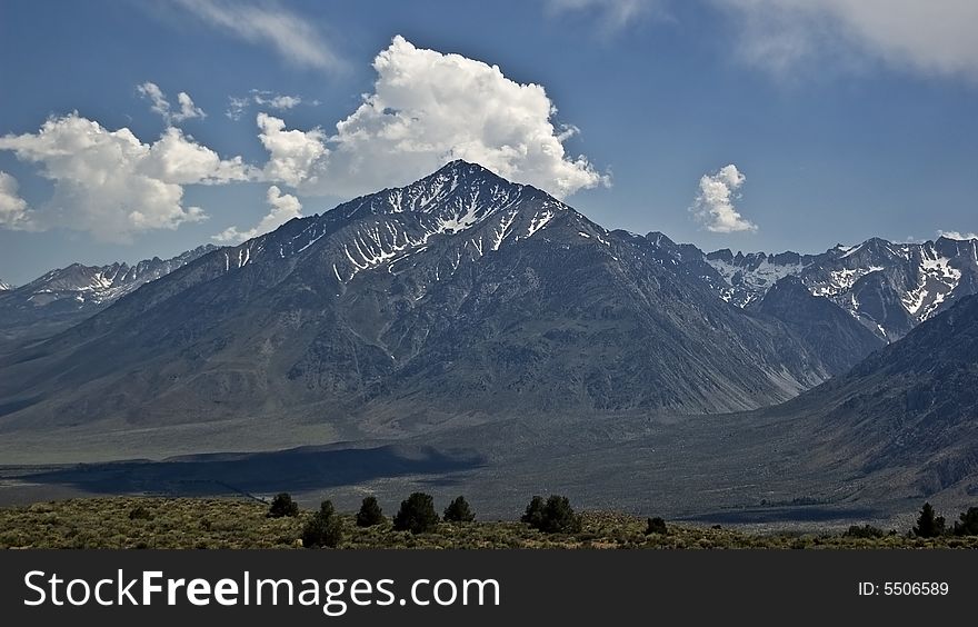Clouds over the high desert landscape in the Eastern Sierra Nevada Mountains in California. Clouds over the high desert landscape in the Eastern Sierra Nevada Mountains in California.