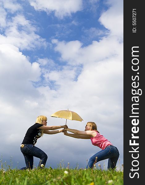 The Two Young Attractive Girls With A Umbrella